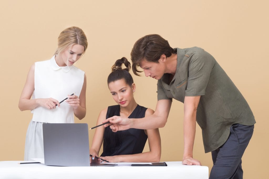 two women and a man looking at a computer image from The Bid Lab's article for IFB and RFPs Explained
