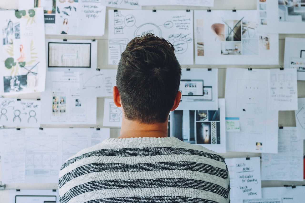 man looking at charts on wall