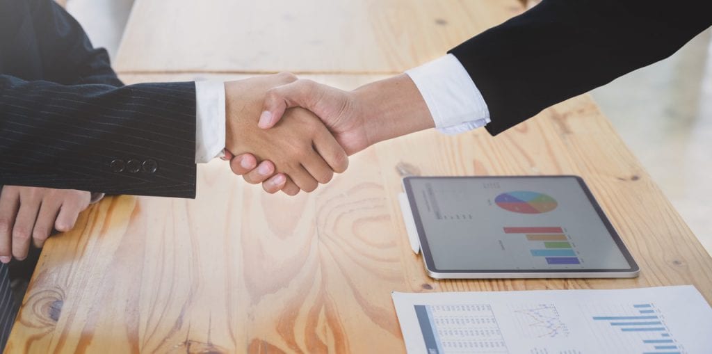 shaking hands over state government contract