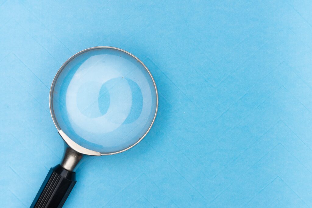 a picture of a magnifying glass against a blue background representing search 