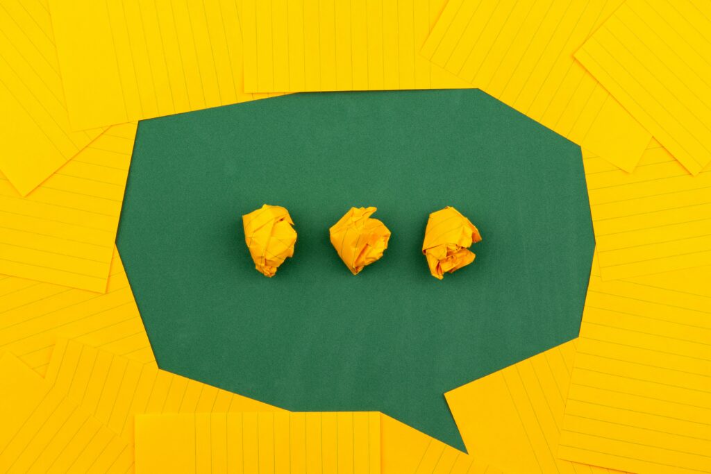 a green speech bubble on a yellow background