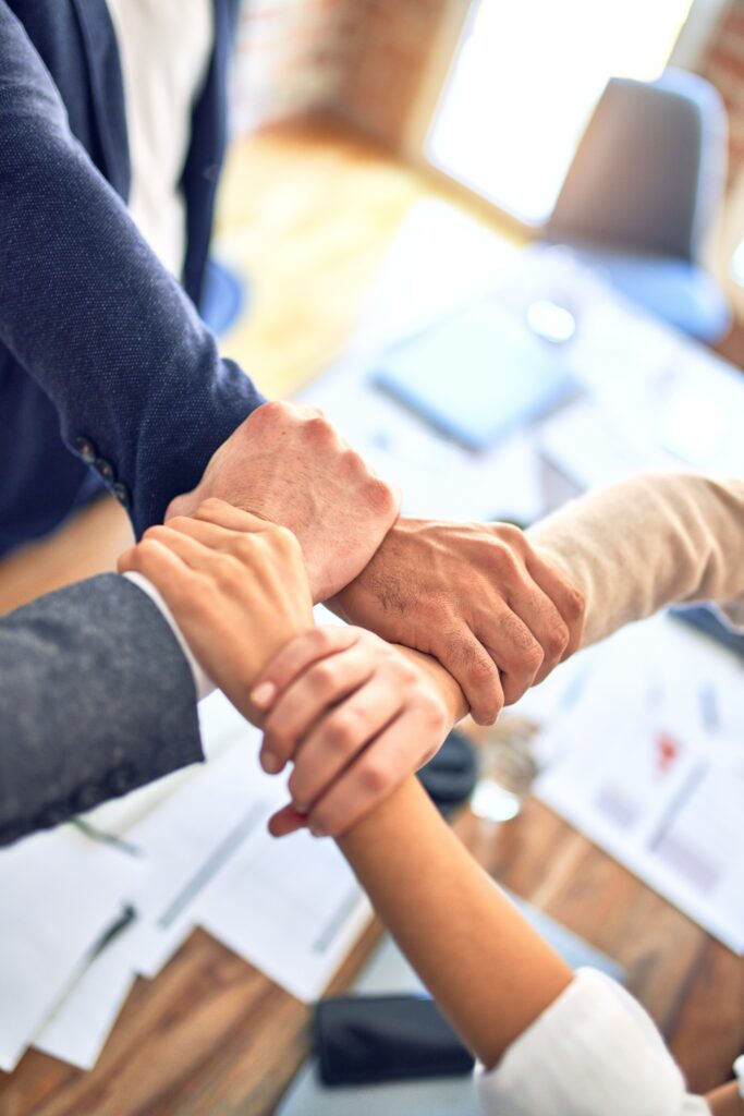 Team members holding hands