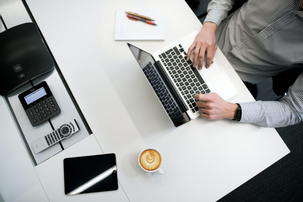 Man typing at a desk. 